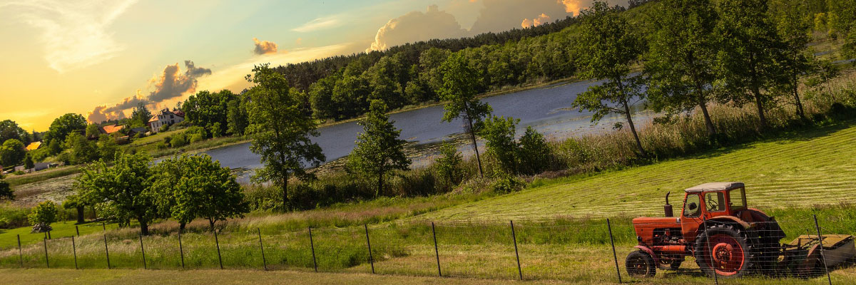 A red tractor plowing farmland